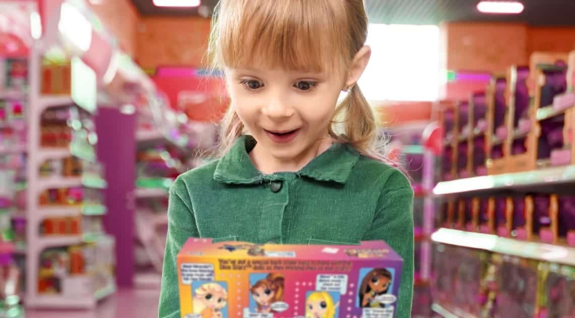 A young girl excitedly holding a colorful product box in a toy store, symbolizing safe and appealing child-resistant packaging design.